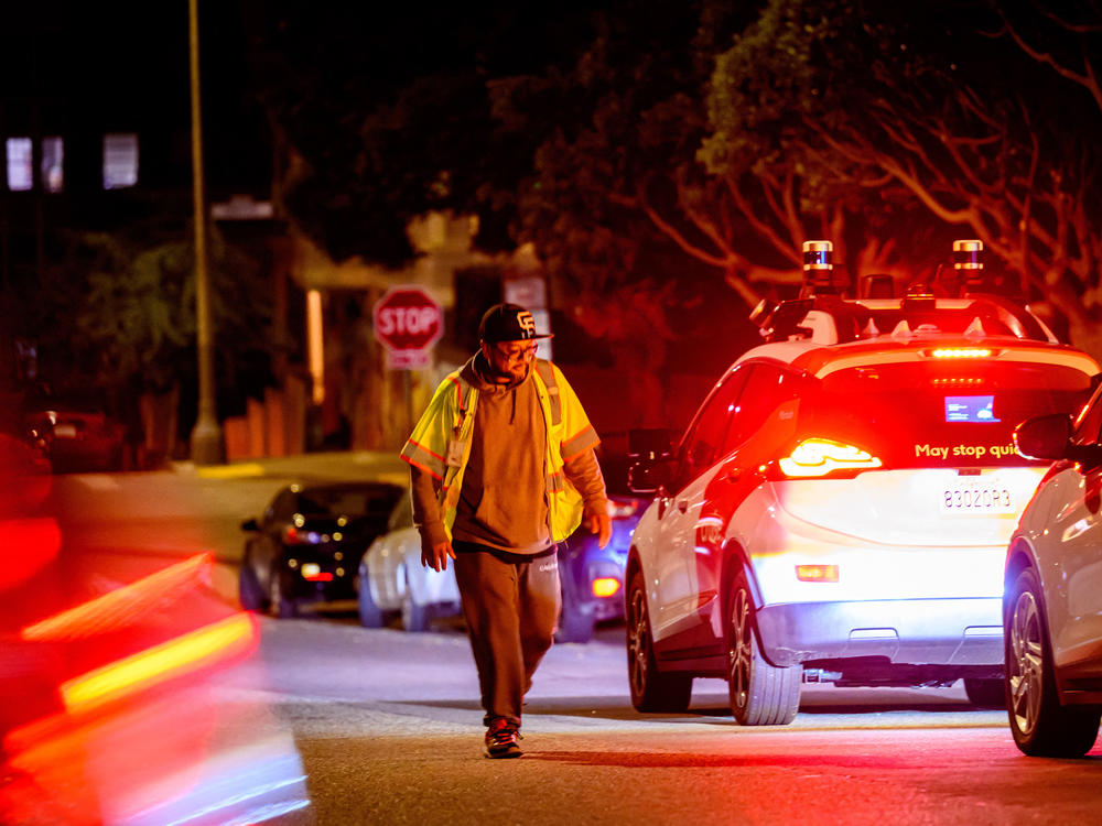 A Cruise technician comes to restart a driverless car in San Francisco.
