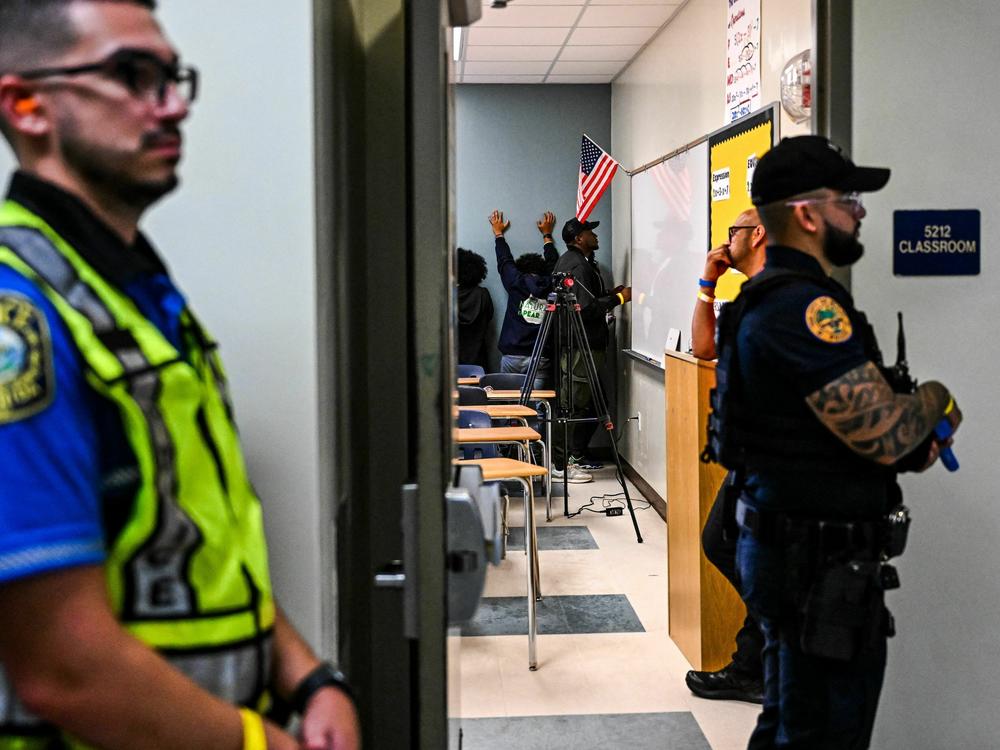 Miami fire and rescue and police officers perform a rescue operation during an active shooter drill at Miami Senior High School in Miami, Fla.