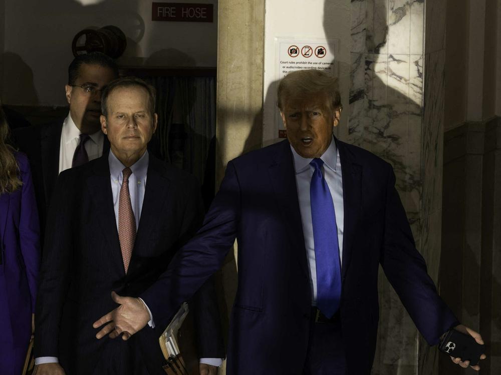 Former President Donald Trump speaks to members of the media as he arrives at New York State Supreme Court where he will face Michael Cohen, who is testifying against him.