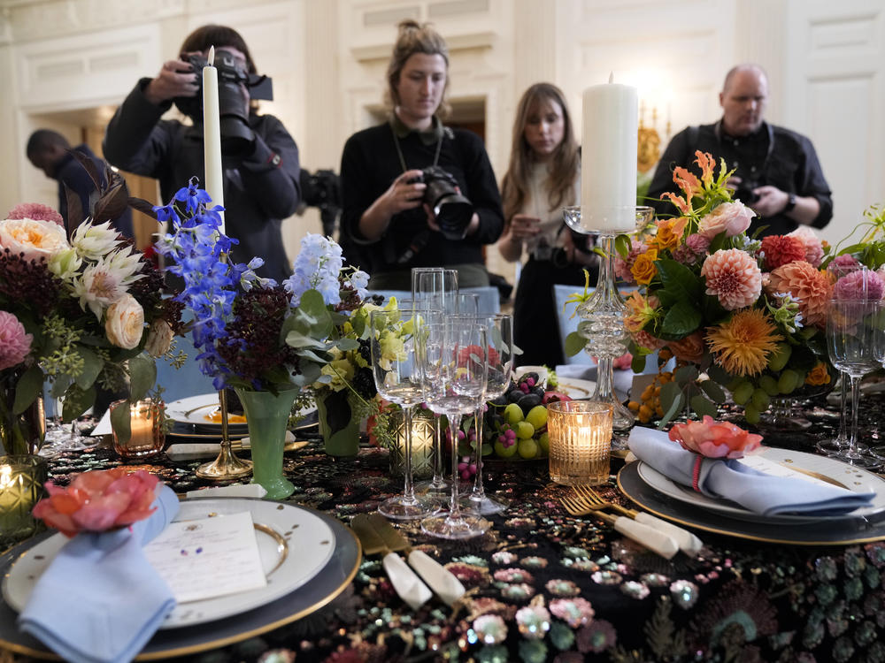 Reporters get a sneak peek at the table setting and menu for President Biden's state dinner for Australia's Prime Minister Anthony Albanese on Oct. 24, 2023.