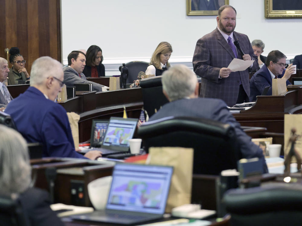 While other senators look at the map on their computers, Republican Sen. Ralph Hise, top right, one of the sponsors of a congressional redistricting bill, speaks as the North Carolina Senate debates the bill Tuesday in Raleigh, N.C.