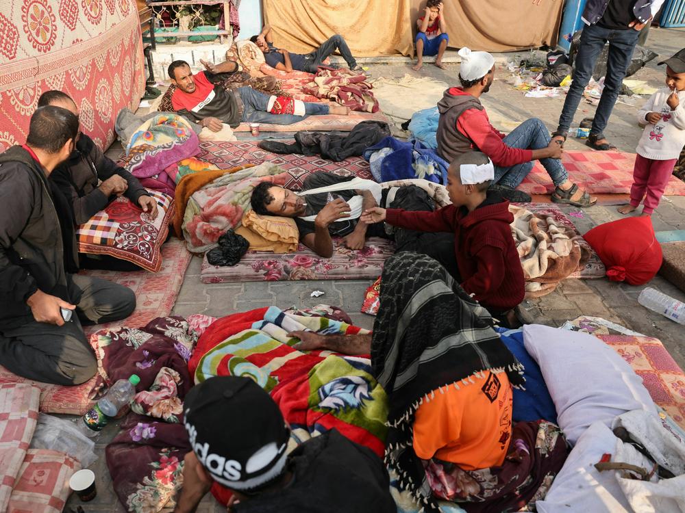 People injured in nearby Israeli strikes rest at a school housing displaced Palestinians in Rafah, on the southern Gaza Strip, on Tuesday.