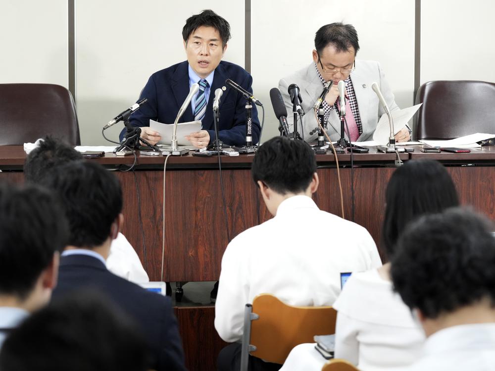 The unnamed plaintiff's lawyers, Kazuyuki Minami, left, and Masafumi Yoshida, right, speak to media after the ruling of the Supreme Court on Wednesday in Tokyo.