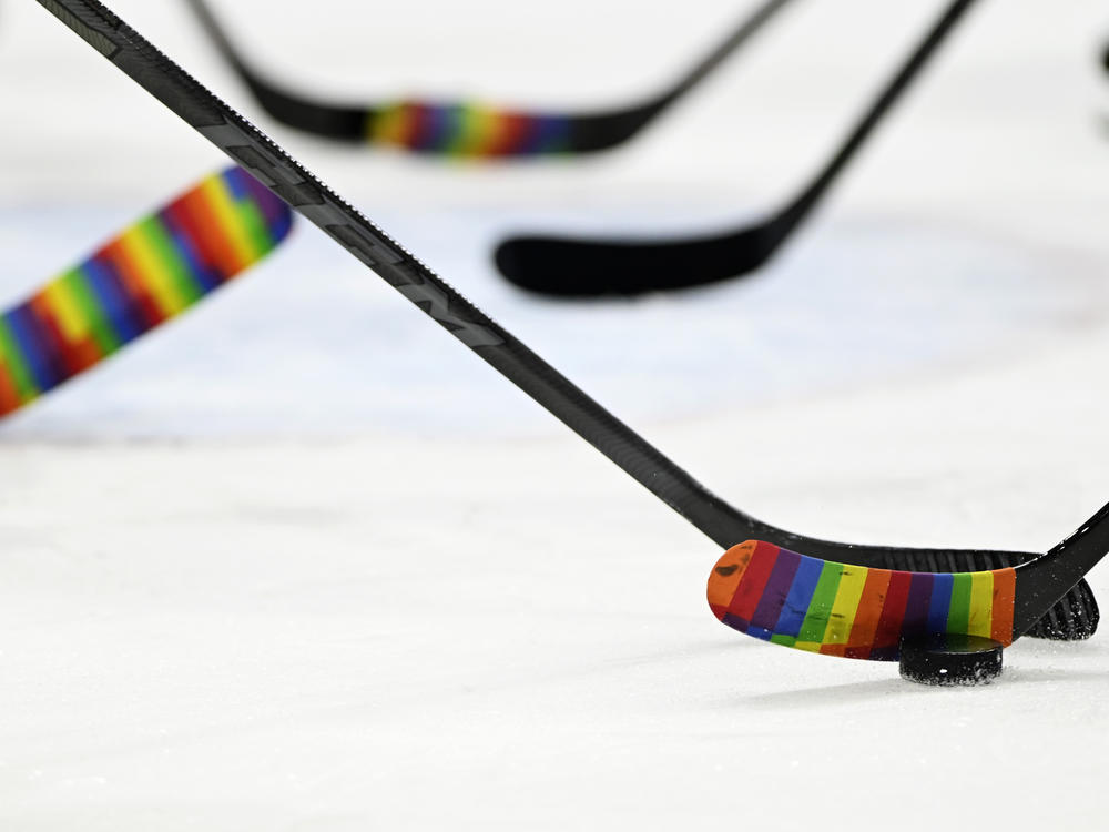 The NHL embraced Pride Tape soon after it was created, then it banned it — and now it is welcoming the colorful tape once again. Here, players warm up before a Pride Night game in 2022.