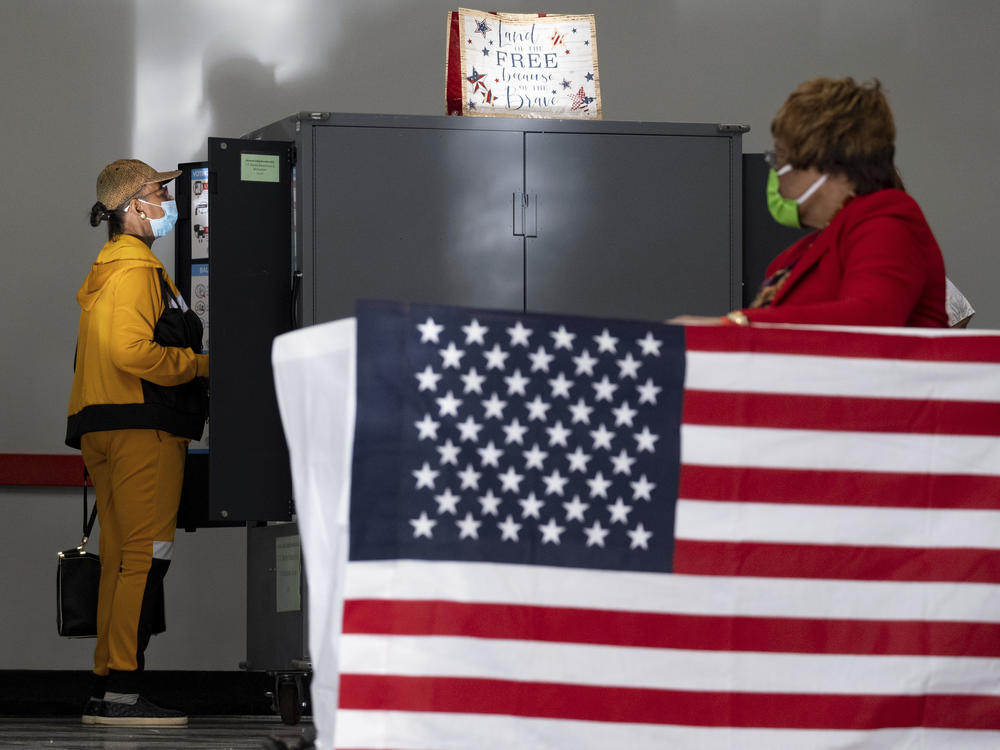 A voter marks her ballot during early voting, on Oct. 17, 2022, in Atlanta.