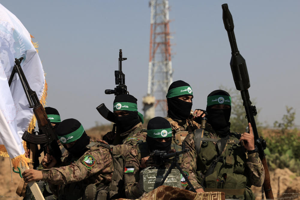 Palestinian fighters of the al-Qassam Brigades, the armed wing of the Hamas movement, march in a military parade to mark the anniversary of the 2014 war with Israel, near the border in the central Gaza Strip on July 19, 2023.