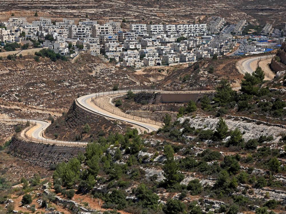 A road extends between the Jewish settlement of Givat Zeev (in the background) and Palestinian villages near the Israeli-occupied West Bank city of Ramallah in September.