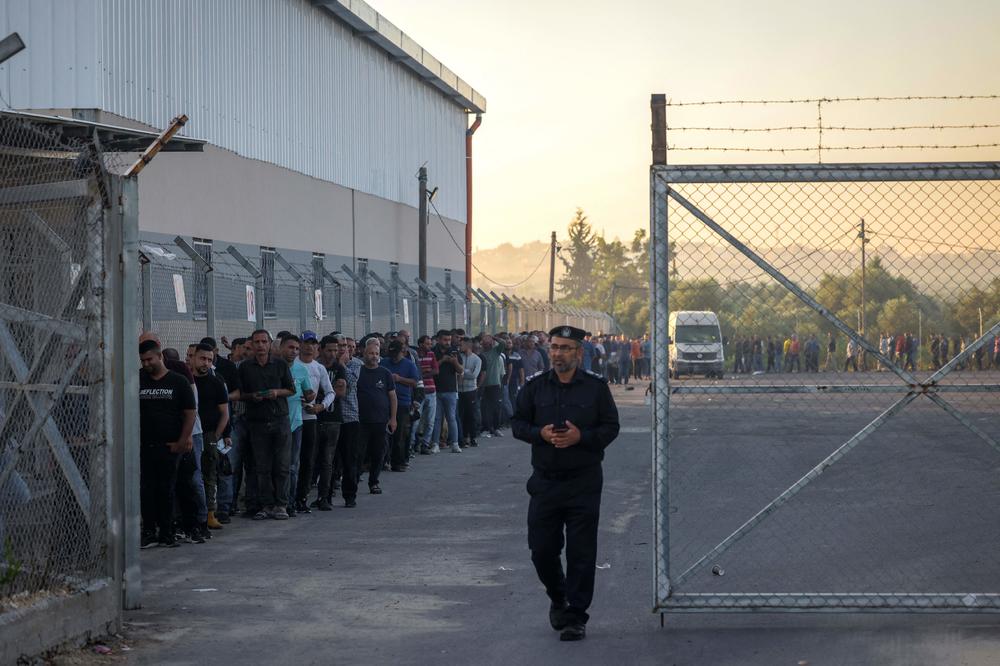 Palestinian workers gather at the Erez crossing between Israel and the northern Gaza Strip, on Sept. 28. Israel declared the crossing shut following the Oct. 7 attack.