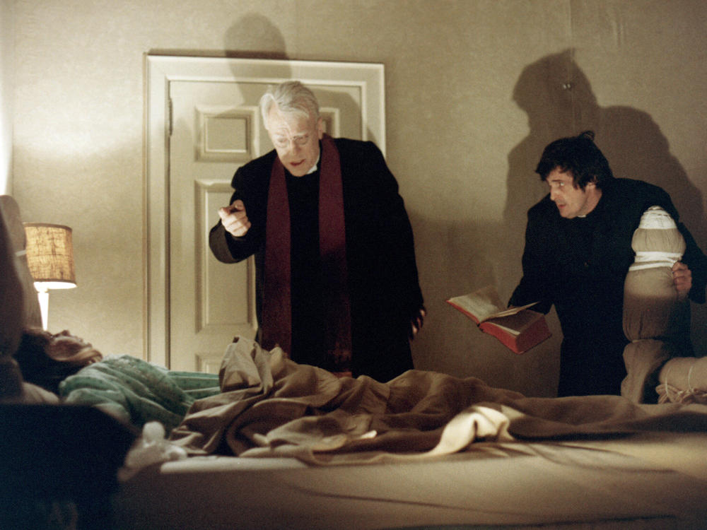 Priests, played by Max von Sydow and Jason Miller, try to help a possessed child in <em>The Exorcist,</em> from 1973.