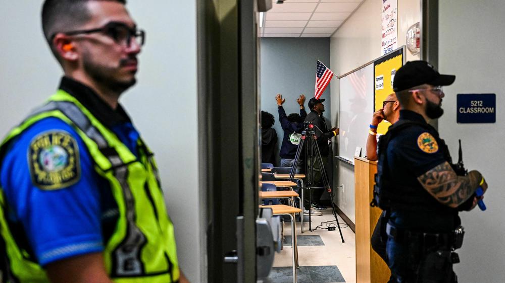 Miami fire and rescue and police officers perform a rescue operation during an active shooter drill at Miami Senior High School in Miami, Fla.