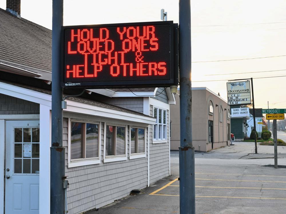 A sign on a closed storefront in Lewiston, Maine, offers support for a community on lockdown on Friday.