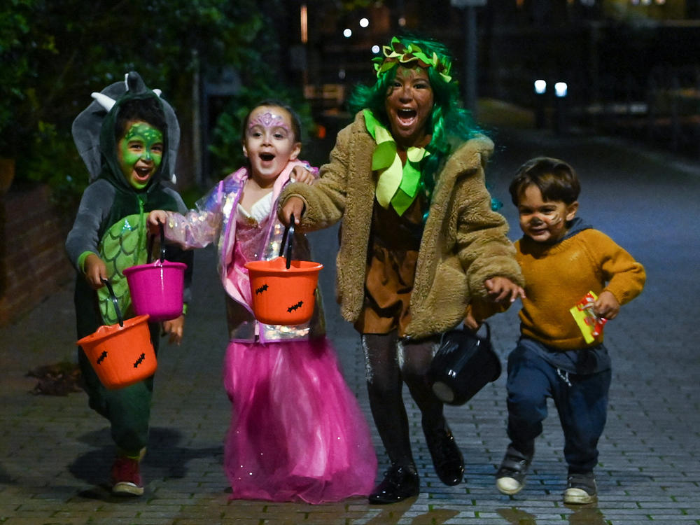 Halloween lets children bring fantasy play into the real world, all while building a sense of community. Here, kids go trick-or-treating during Halloween in  London in 2020.