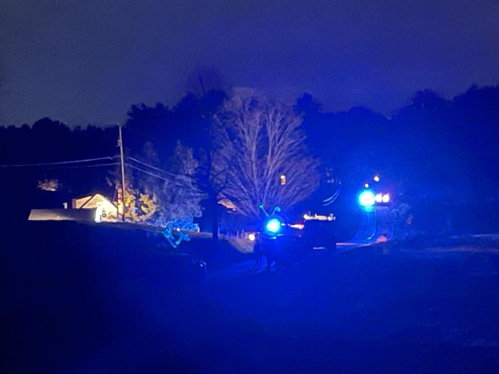 Law enforcement officials surround a house on Meadow Road in Bowdoin, Maine.