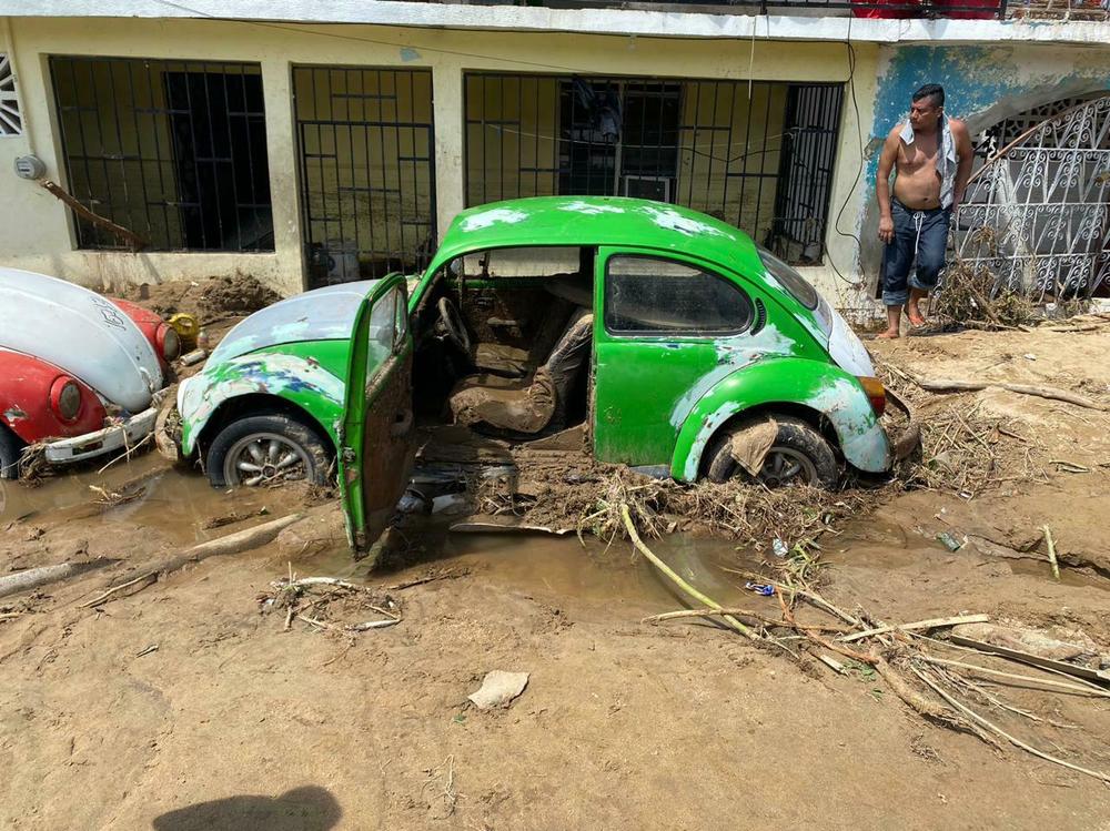 The Volkswagen of Abel Sandoval filled with mud after Hurricane Otis sent walls of mud and water rushing through the working-class neighborhood of Zapata.