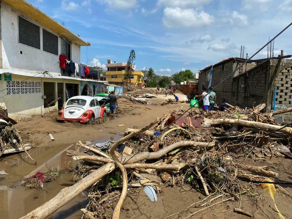 A river carried mud and downed trees in the Zapata neighborhood on the outskirts of the city of Acapulco, Mexico, after Hurricane Otis swept through the area.