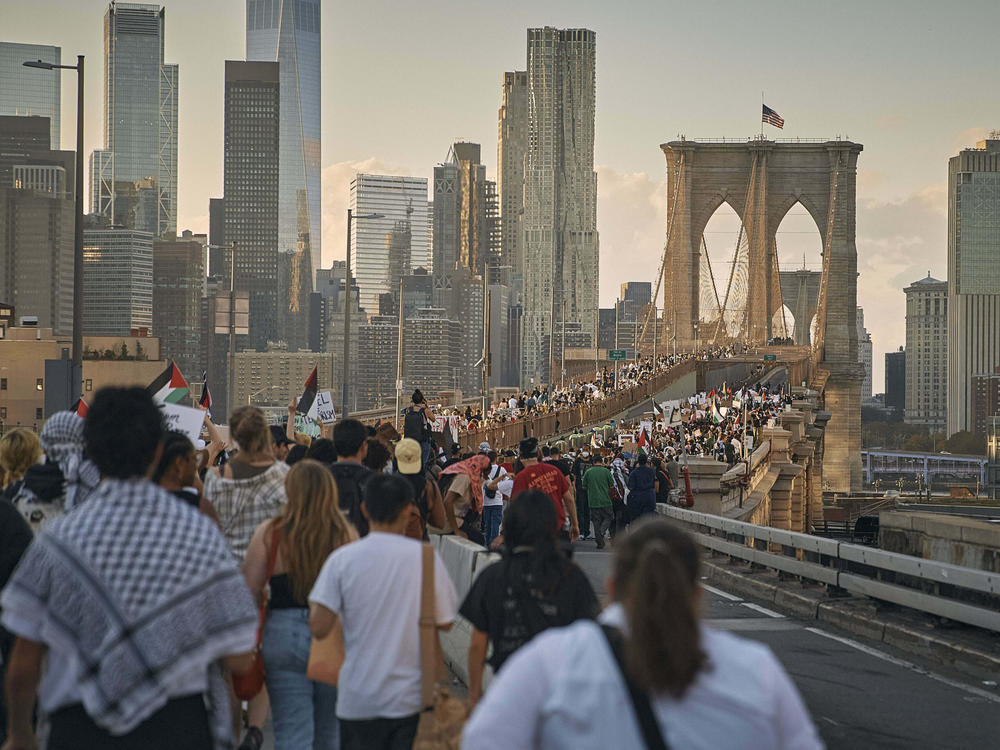 Protesters march as they cross the Brooklyn Bridge during a pro-Palestinian demonstration demanding a cease-fire on Saturday in New York City.