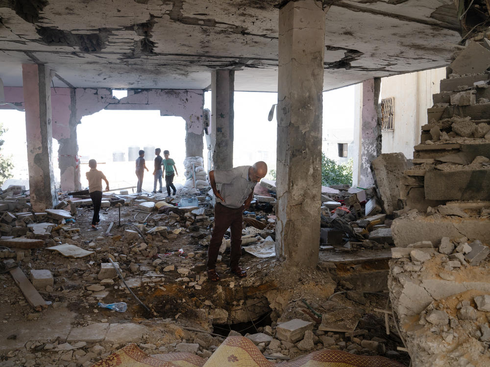 People walk through the ruins of Al-Ansar Mosque in Jenin refugee camp in the northern occupied West Bank that was hit last week by an Israeli airstrike.