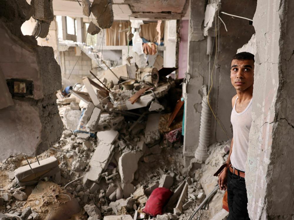 A man stands amid the rubble of a building in the aftermath of Israeli bombing in Rafah in the southern Gaza Strip on Sunday.