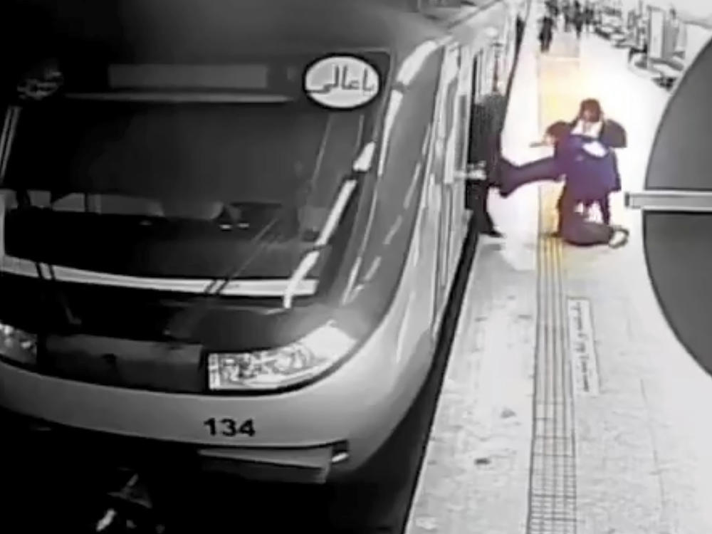 In this image from surveillance video aired by Iranian state television, women pull 16-year-old Armita Geravand from a train car on the Tehran Metro in Tehran, Iran, Sunday, Oct. 1, 2023.