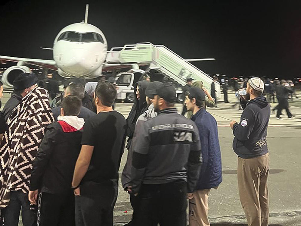 A crowd swarms the airfield of the airport in Makhachkala, capital of Dagestan in southern Russia, on Sunday night.