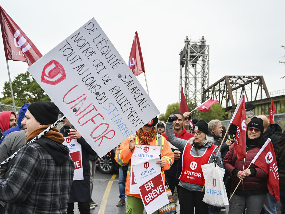 Striking St. Lawrence Seaway workers picket outside the St. Lambert Lock in St. Lambert, Quebec, Monday, Oct. 23, 2023.