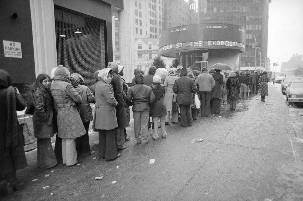 Despite sub-freezing temperatures and rain, a crowd waits in line outside the Paramount Theater in New York City for a showing of The Exorcist in February 1974.
