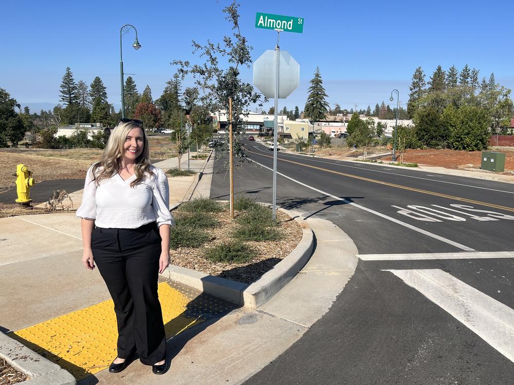 Paradise recovery coordinator Colette Curtis stands along a newly finished streetscaping  project in what town leaders hope will be a new central business district.