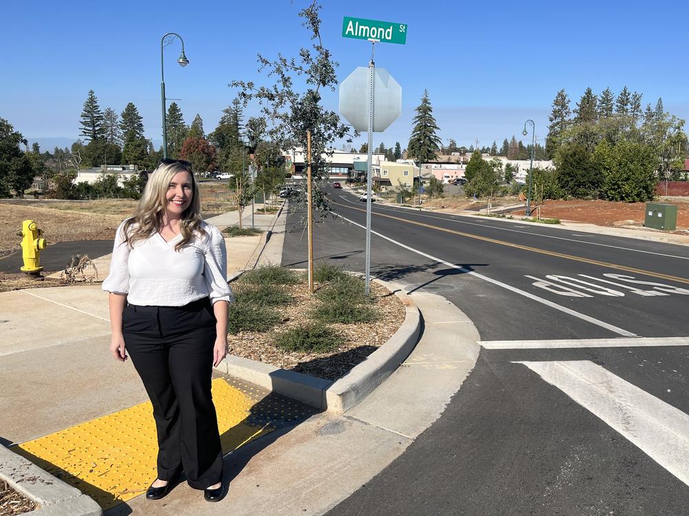 Paradise recovery coordinator Colette Curtis stands along a newly finished streetscaping  project in what town leaders hope will be a new central business district.