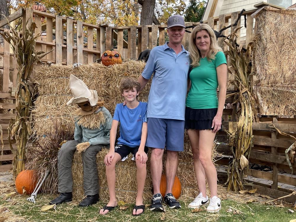 Kurt and Heather Denchfield, with their son Jake, pose in their front yard, which is about to mutate into a haunted maze.