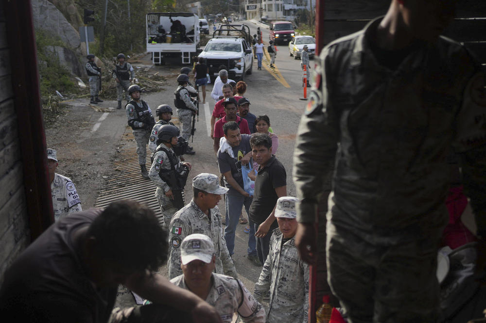 <strong>Oct. 28:</strong> Soldiers stand guard during a food delivery, in the aftermath of Hurricane Otis in Acapulco, Mexico.