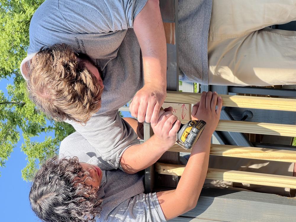 Two youths incarcerated at the Backbone Mountain Youth Center in western Maryland participate in a community service project.