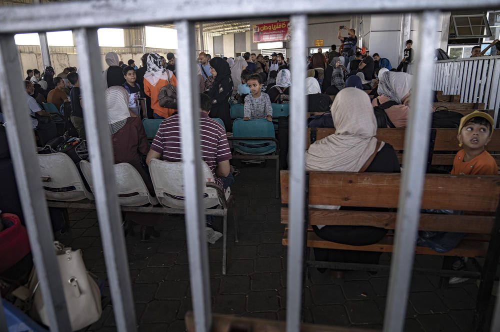 Palestinians wait to cross into Egypt at Rafah, Gaza Strip.
