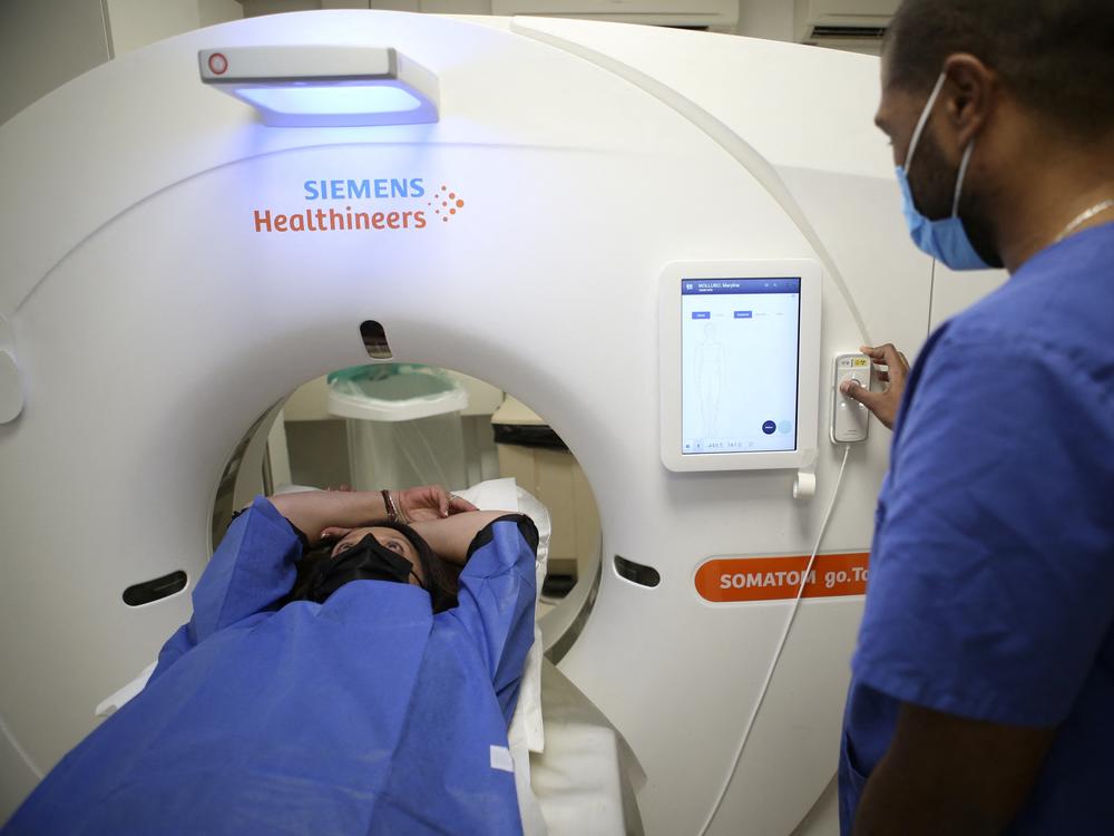 A patient gets a low-dose CT scan to screen for lung cancer. The American Cancer Society on Wednesday recommended expanding who should have this annual screening test.