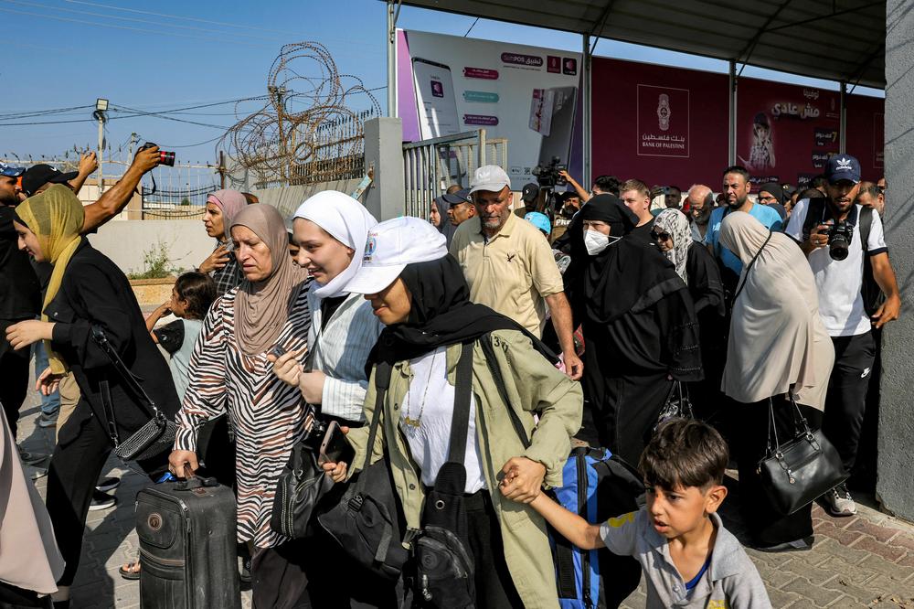 People walk through a gate to enter the Rafah border crossing to Egypt in the southern Gaza Strip.