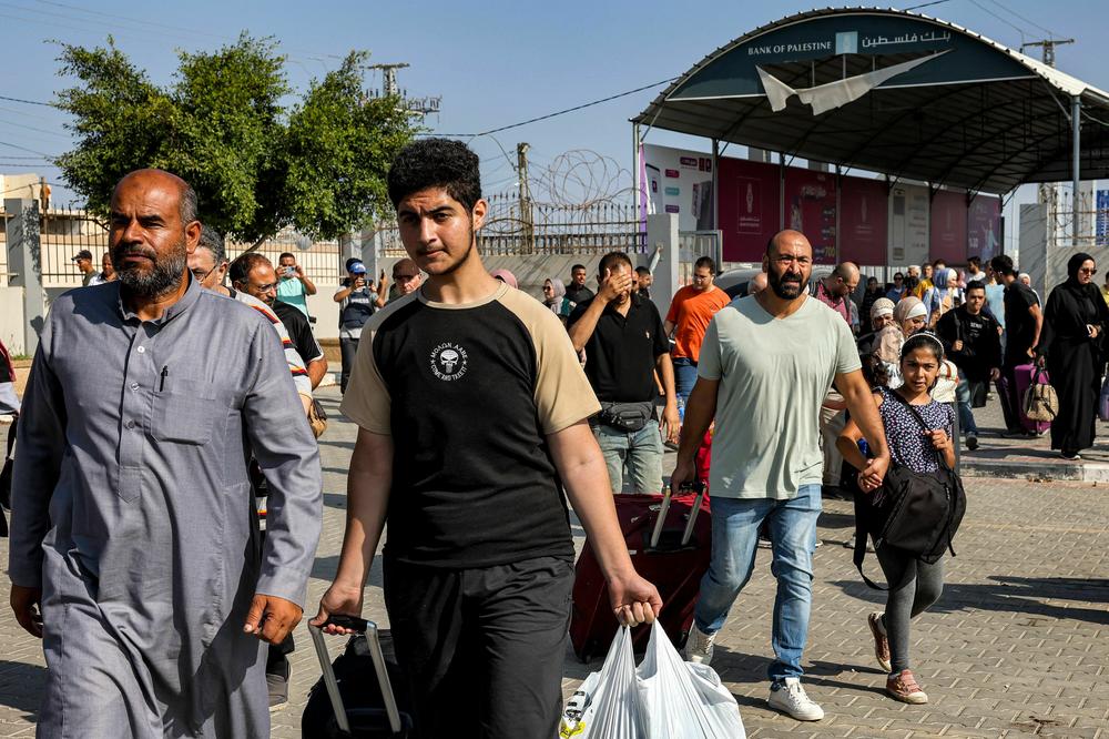 Crowds of people showed up on the Palestinian side of the border, including children. They gathered at the terminal separating Egypt from Gaza, many of them carrying suitcases and some with donkey-pulled carts loaded with luggage.
