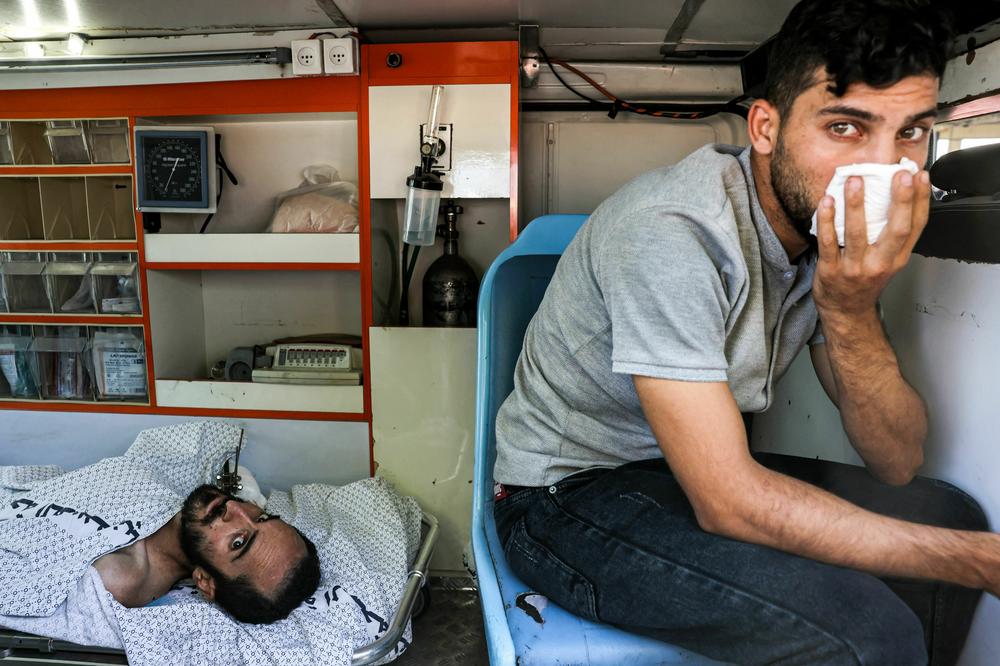 An injured man lies inside an ambulance waiting at the Rafah border crossing in the southern Gaza Strip before receiving medical care in Egypt.