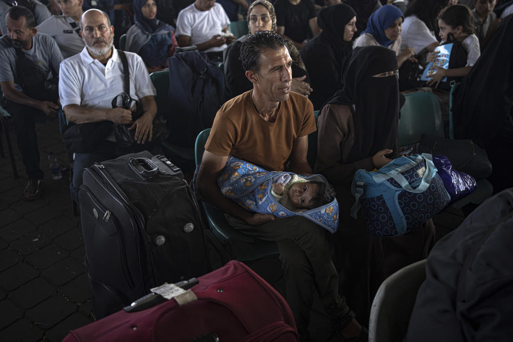 Palestinians wait to cross into Egypt at Rafah, Gaza Strip, on Wednesday, Nov. 1, 2023.