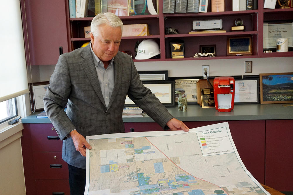 Casa Grande Mayor Craig McFarland holds a map showing land with and without a water supply. 