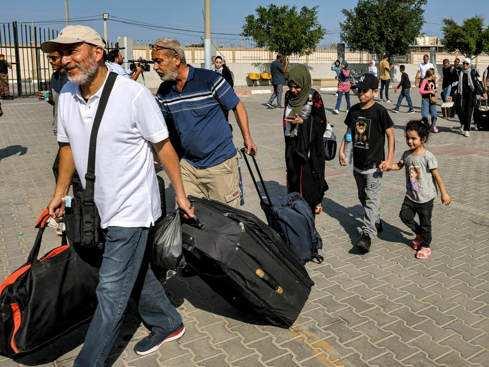 People enter the Rafah border crossing in the southern Gaza Strip before crossing into Egypt on Wednesday.