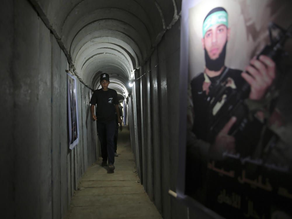 A Palestinian youth walks inside a tunnel used for military exercises during a Hamas-run camp in 2016. Hamas says it has built 300 miles of tunnels under Gaza.