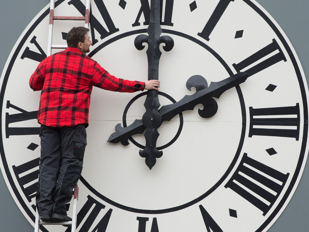 This picture taken in March 2018 shows a technician working on the clock of the Lukaskirche Church in Dresden, eastern Germany. This weekend, Americans will wind back this clocks as daylight saving time ends.