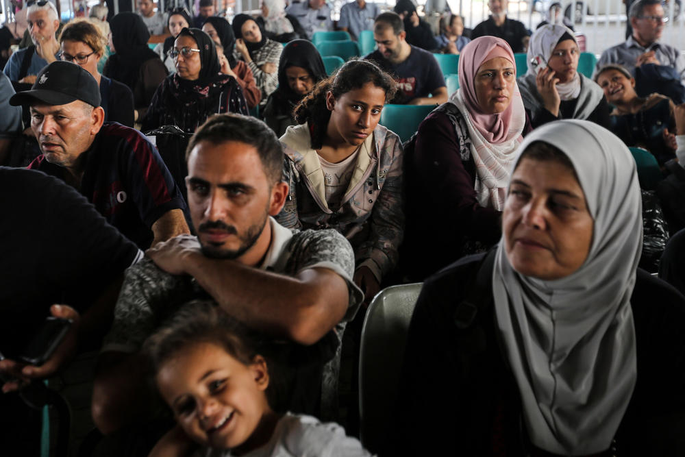 Citizens with foreign passports wait to travel through the Rafah crossing on Thursday. At least 300 civilians, all of them foreign citizens or dual nationals, departed Gaza Wednesday.