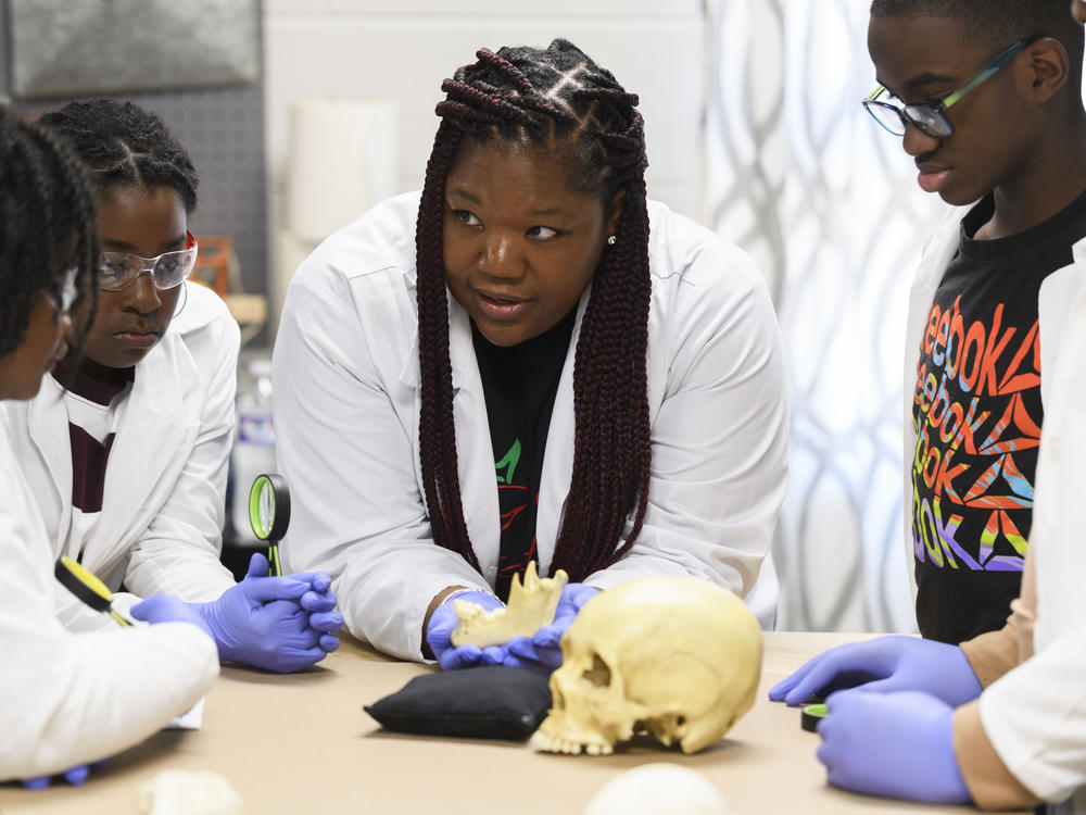 Using a plastic skull, archaeologist Alicia Odewale teaches a lesson about Tulsa's ongoing search for mass graves containing victims of the city's 1921 race massacre. She taught it at Black History Saturdays, a free private program designed for students to learn unvarnished lessons in African American history that teachers say a new law targeting race education has made harder to honestly teach.