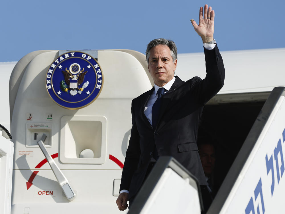 U.S. Secretary of State Antony Blinken waves as he disembarks from an aircraft on his arrival in Tel Aviv, Israel, on Friday.