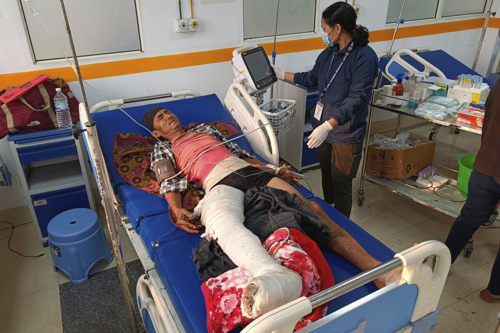 A doctor looks after a patient injured in an earthquake, evacuated from his village and brought to a hospital in Nepalgunj, Nepal, on Saturday.