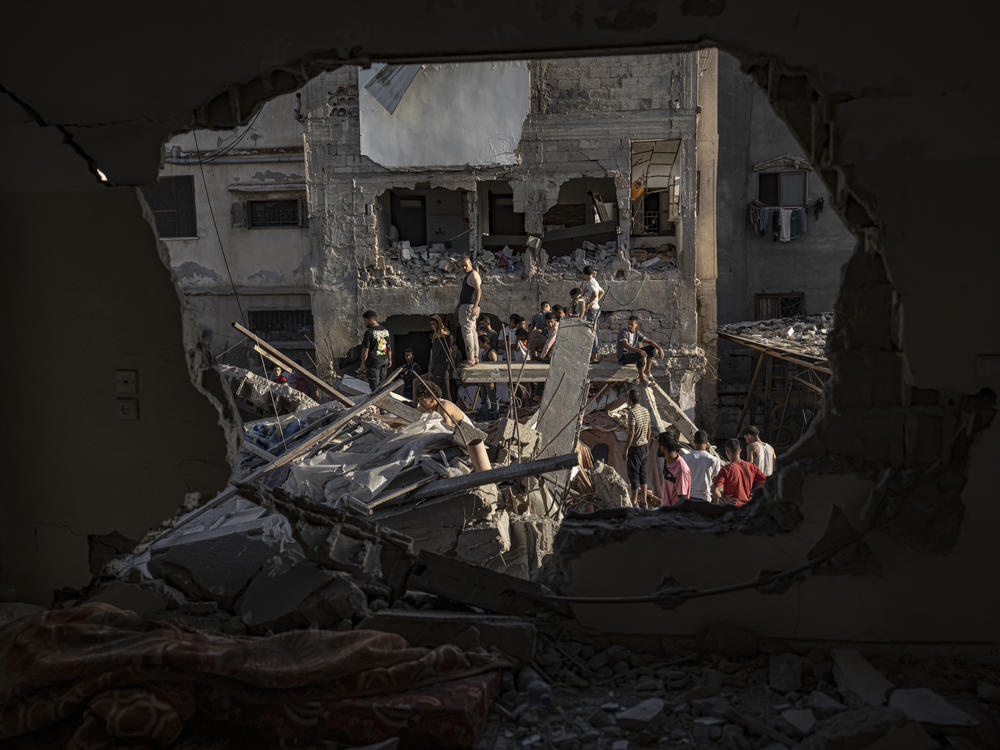 Palestinians look at the destruction after Israeli strikes on the Gaza Strip in Khan Younis on Saturday.
