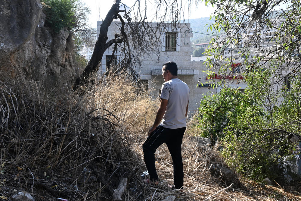 Mahmoud in his village across from the Ein Erik refugee camp where he lives.