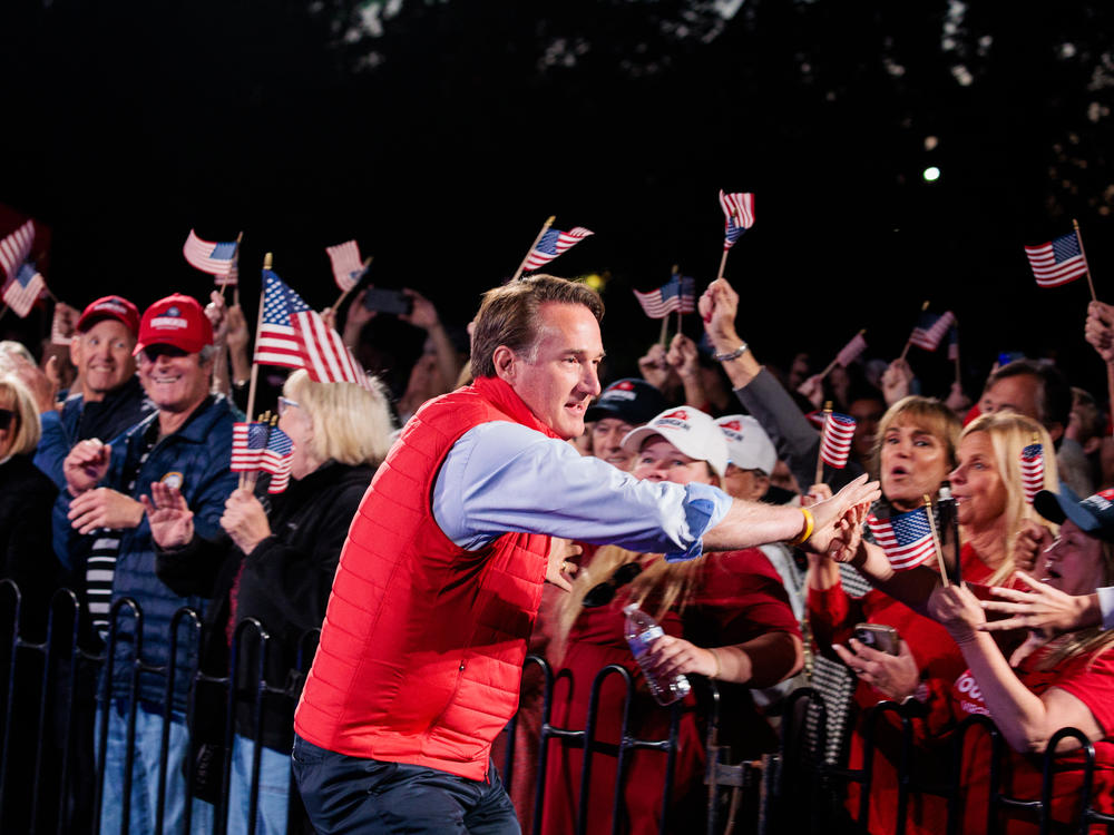 Gov. Glenn Youngkin shakes hands with supporters during a Secure Your Vote Rally on Oct. 23 in Glen Allen, Va.