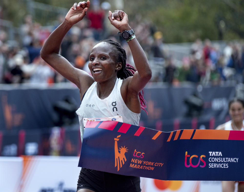 Hellen Obiri of Kenya crosses the finish line to win the women's division of the New York City Marathon on Sunday, in New York.