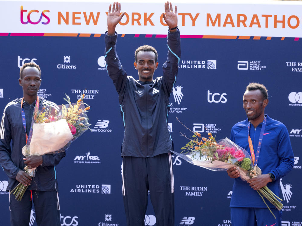 From left, second place finisher Albert Korir of Kenya, first place finisher Tamirat Tola, of Ethiopia, and third place finisher Shura Kitata, also from Ethiopia, pose after the men's division of the New York City Marathon on Sunday.